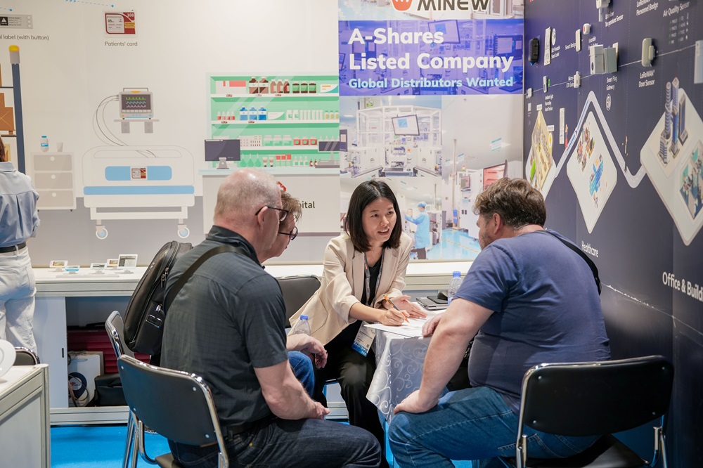 MinewTag representatives interacting with customers at the exhibition.